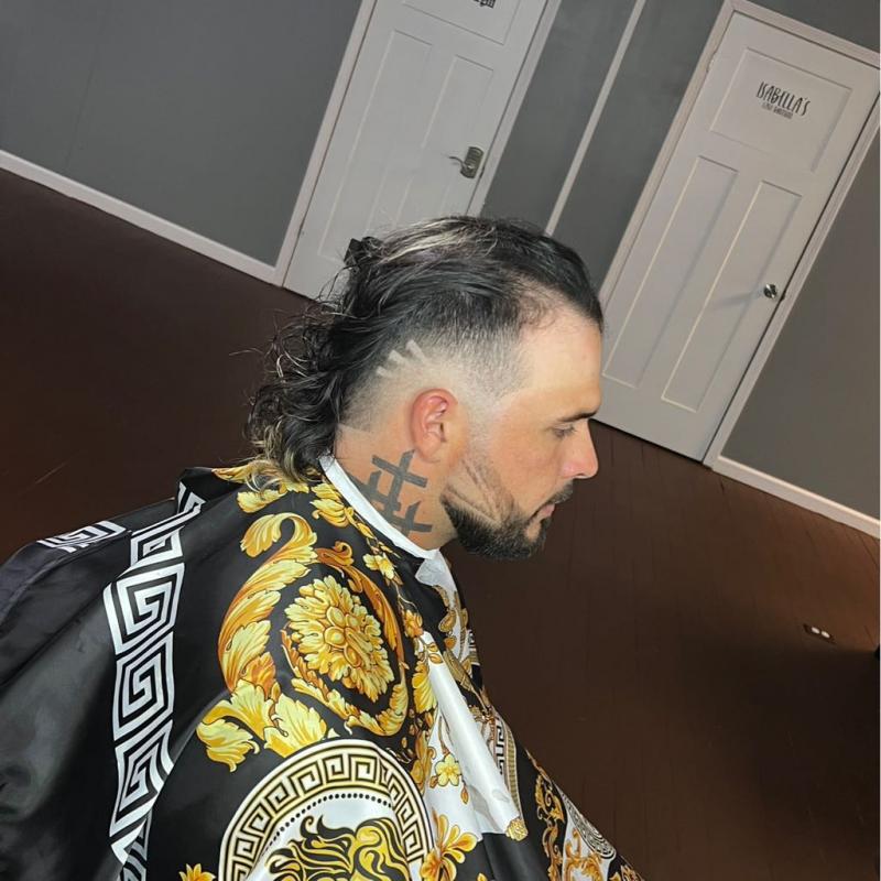 Professional fade with textured top styling at Cut to a T