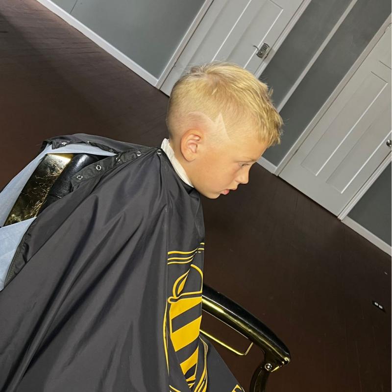 Bold blonde fade haircut with sharp line work